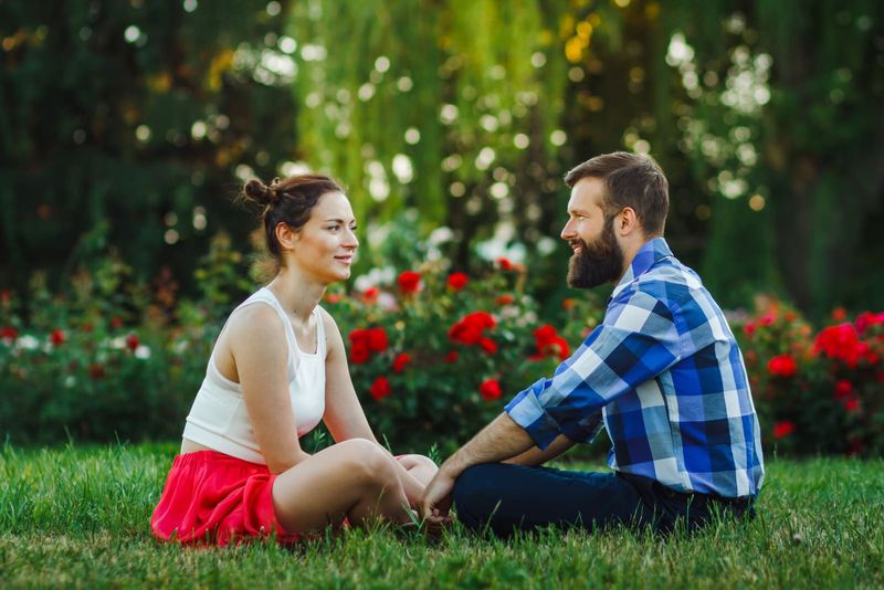 Paar im Gespräch im Freien - sitzen auf dem Rasen