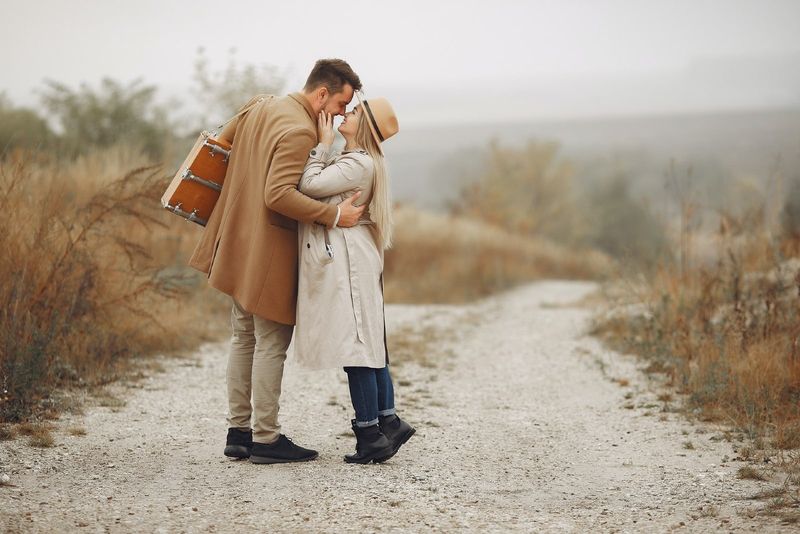 Mann und Frau wollen sich küssen, während sie auf einem ländlichen Weg stehen