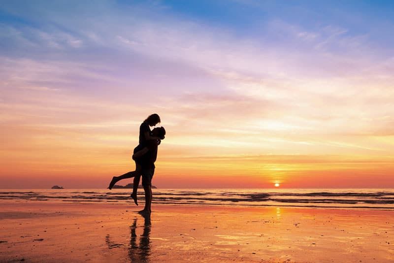 glückliches Paar am Strand im Sonnenuntergang