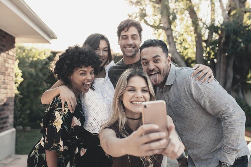 gruppe junger leute, die ein selfie machen und feiern